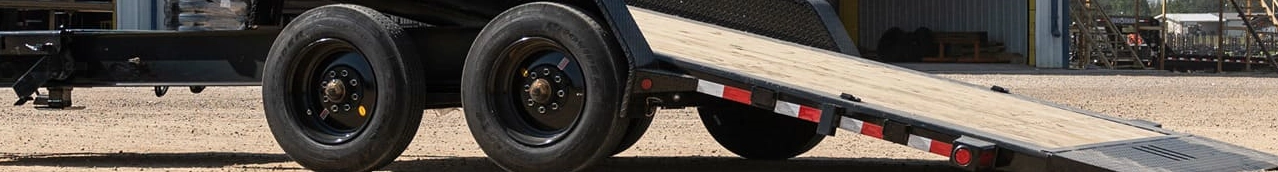 Close-up of a trailer ramp with dual axles.